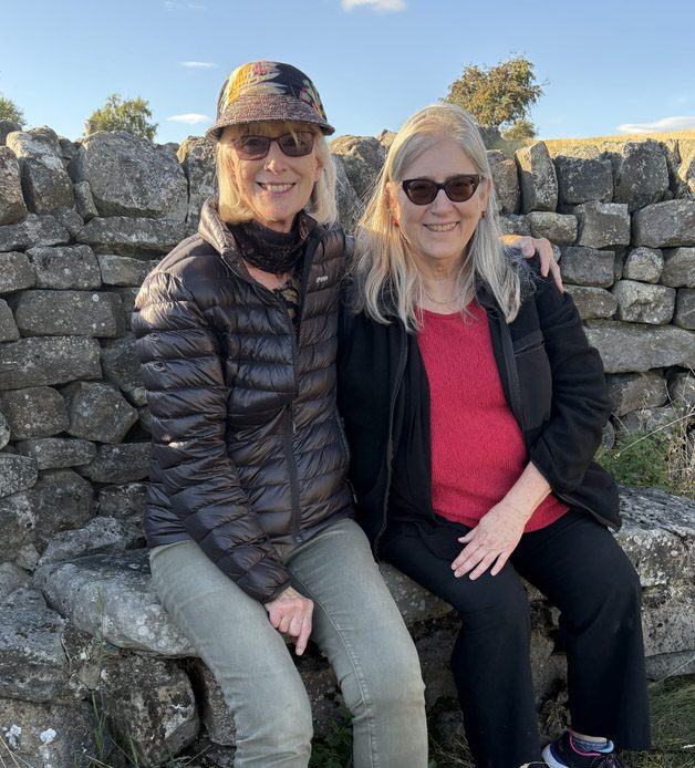 Two women novelists of a certain age — Stella Fosse and Stephanie Shields on the stone seat above Timble Gill.